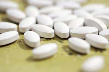 white magnesium tablets on a green-yellow table