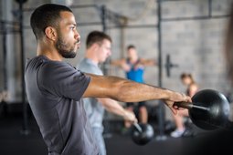 Man doing kettlebell workout at the gym