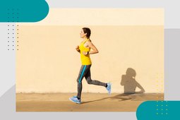 runner wearing yellow tank top and gray leggings in front of light yellow wall