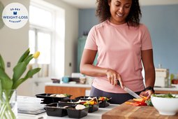 woman slicing vegetables for portion controlled meals