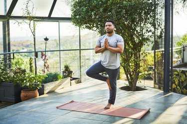 adult doing tree pose as an example of a balance exercise, a natural remedy for vertigo