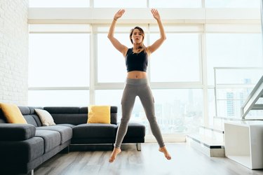 Adult Woman Training Legs Doing Squat and Jumping